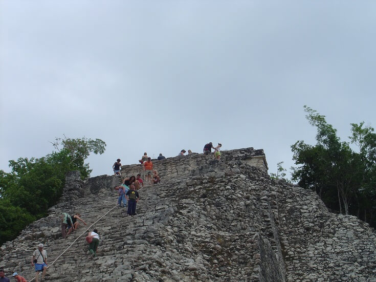 Hikers make their way up the steep side of Coba