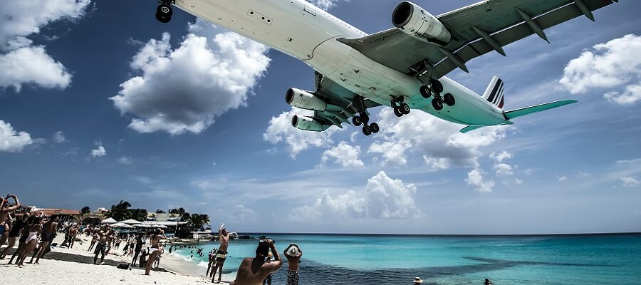 A large plane lands just feet over the beach in St Maarten.
